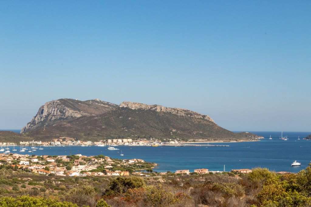 Beautiful view of Golfo Aranci, Sardinia featuring sea, hills, and sailing boats
